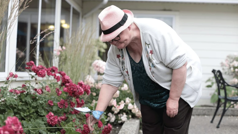 An elderly woman gardening at WHM